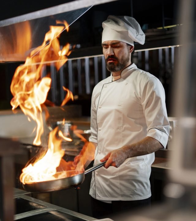 chef-cooking-kitchen-while-wearing-professional-attire