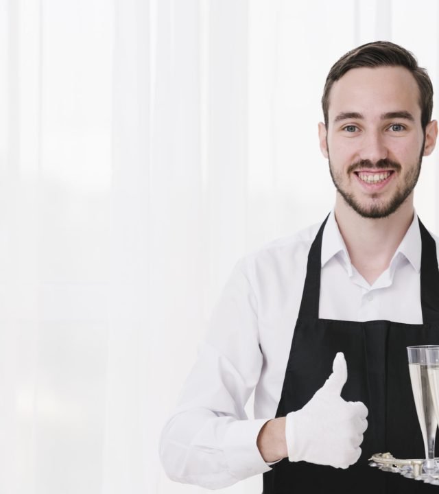 happy-servant-carrying-champagne-glasses-with-copy-space